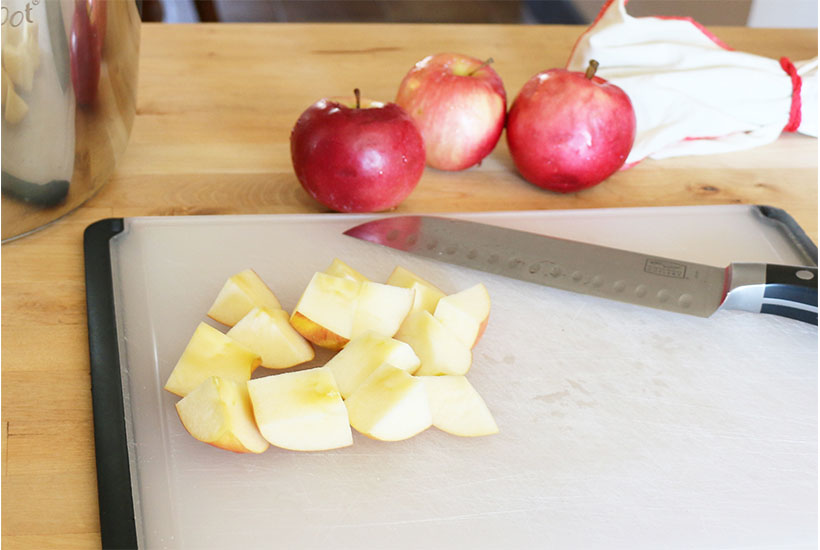 Apples on cutting board for making no peel applesauce.
